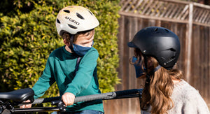 Boy looking at mother wearing STC Next Health antimicrobial masks